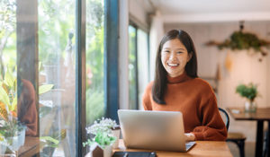 Woman using user profiles on laptop